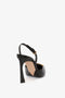 A timeless Victoria Beckham Pointy Toe Sling back in Black Calf with an ankle strap and gold buckle, featuring a pointed toe, viewed from the back on a white background.