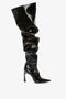 A single, glossy black Thigh High Pointy Boot in Black Patent by Victoria Beckham with a slouchy shaft and pointed toe, featuring a high heel, serves as a sophisticated finishing touch against a plain white background.