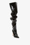 A single Thigh High Pointy Boot in Black Patent by Victoria Beckham with a pointed toe and a high stiletto heel against a white background. This stunning piece offers a sophisticated finishing touch to any ensemble.