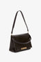 Dark brown croc-effect **Jumbo Chain Pouch Bag In Chocolate Croc-Effect Leather** by **Victoria Beckham** with gold hardware and an adjustable shoulder strap, perfect for versatile styling. Displayed against a white background.