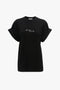 A Victoria Beckham 'Do As I Say, Not As I Do' Slogan T-Shirt In Black crafted from organic cotton, featuring cuffed sleeves and the text "Do as I say, NOT as I Do" printed on the chest.