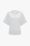 A plain white Bonded Jersey Tee In White by Victoria Beckham with a relaxed cut is displayed against a solid white background.