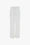 Contemporary cool Victoria Beckham white wide-leg trousers on a plain white background.