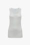 A white, sleeveless Fine Knit Vertical Stripe Tank In White with a round neckline, crafted from breathable lightweight ribbed knit by Victoria Beckham, displayed on a plain background.