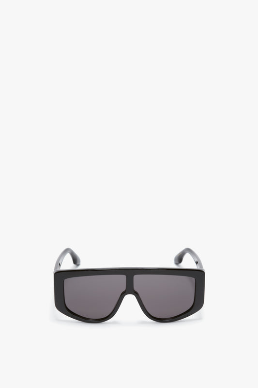 A pair of Acetate Visor Sunglasses In Black with dark lenses on a white background, featuring Victoria Beckham’s signature oversized frames.