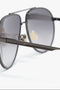 Close-up of V Metal Pilot Sunglasses In Grey Gradient featuring a metallic frame and gunmetal grey gradient tinted lenses, with the name "Victoria Beckham" engraved on the temple.