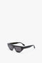 A pair of black rectangular Victoria Beckham Layered Lens Visor Sunglasses In Black with thick frames and dark lenses pictured on a plain white background, perfect for adding a touch of chic to your SS24 style.