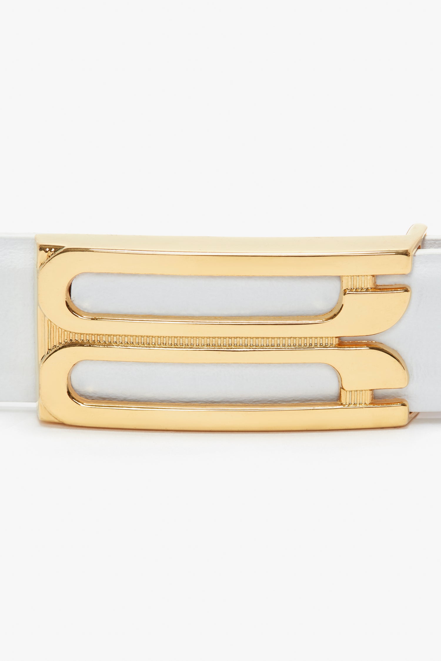 Close-up of a gold rectangular belt buckle with two parallel cut-out slots, attached to a Victoria Beckham Frame Belt In White Leather.