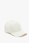 A Victoria Beckham Logo Cap in Antique White with a curved brim and an adjustable snap, shown against a white background.