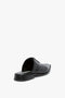 A black Flat Lace Up Mules In Black Leather with slip-on construction viewed from the back on a plain white background.