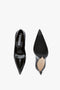 Top and bottom view of a pair of black pointed-toe V Pump In Black Brushed Leather by Victoria Beckham with sculptural heels on a white background.