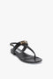 A single Victoria Beckham Flat Chain Sandal In Black Leather with a gold buckle, thong front, ankle strap, and signature chain detail.