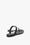 A Victoria Beckham Flat Chain Sandal In Black Leather, featuring a back strap buckle and minimalist design, with a signature chain detail on a plain white background.