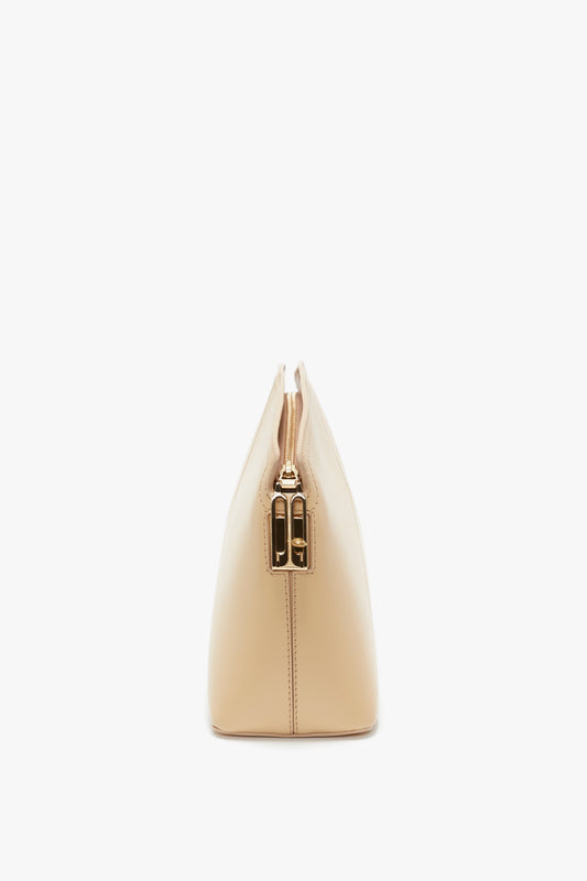 Side view of a Victoria Clutch Bag In Sesame Leather from Victoria Beckham with a metallic clasp at the top, placed on a white background, perfect for SS24 runway inspiration.