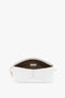 An open Exclusive Victoria Clutch Bag In White Leather by Victoria Beckham, reminiscent of Victoria Beckham's structured design, showcases a brown interior with a small inner pocket and gold zipper closures.