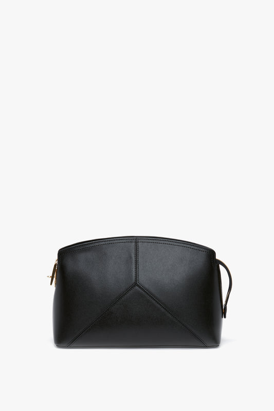 A black leather pouch with a zip closure and geometric stitch detailing on the front, this Victoria Beckham Victoria Clutch Bag In Black Leather showcases a structured silhouette ideal for any stylish ensemble.