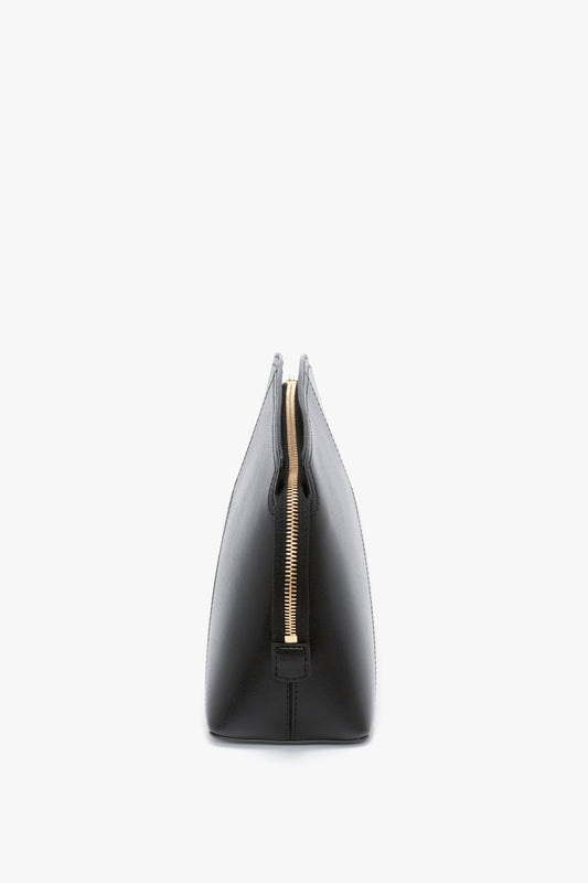 Side view of the Victoria Clutch Bag In Black Leather by Victoria Beckham, showcasing its structured silhouette.