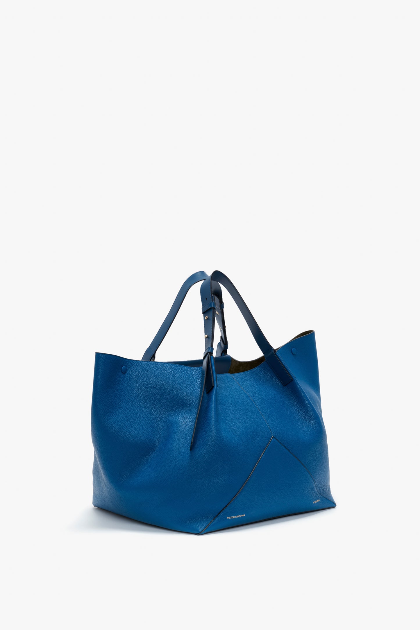 A W11 Medium Tote Bag In Vibrant Blue Leather by Victoria Beckham, featuring double handles, adjustable straps, and a minimalistic design.