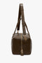 A Medium Gym Bag In Olive by Victoria Beckham with gold-toned hardware, an adjustable strap, and a lock hanging from the zipper pull on a white background.