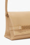 Mini Pouch With Long Strap In Sesame Leather by Victoria Beckham, isolated on a white background.