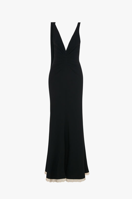 A sleeveless, V-Neck Gathered Waist Floor-Length Gown In Black by Victoria Beckham with a deep V-neck and a slightly flared hem.