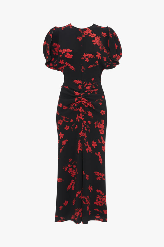 A Gathered Waist Midi Dress In Sci-Fi Black Floral by Victoria Beckham, featuring puffed short sleeves and a ruched detail at the waist, displayed on a plain white background.