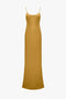 A Victoria Beckham Low Back Cami Floor-Length Dress In Harvest Gold with thin spaghetti straps and a subtle flare at the hem.