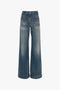 A pair of Victoria Beckham Alina High Waisted Jean In Indigrey Wash with front patch pockets, a single button closure, and light fading on the thighs, perfect for a vintage denim look reminiscent of seventies-style fashion.