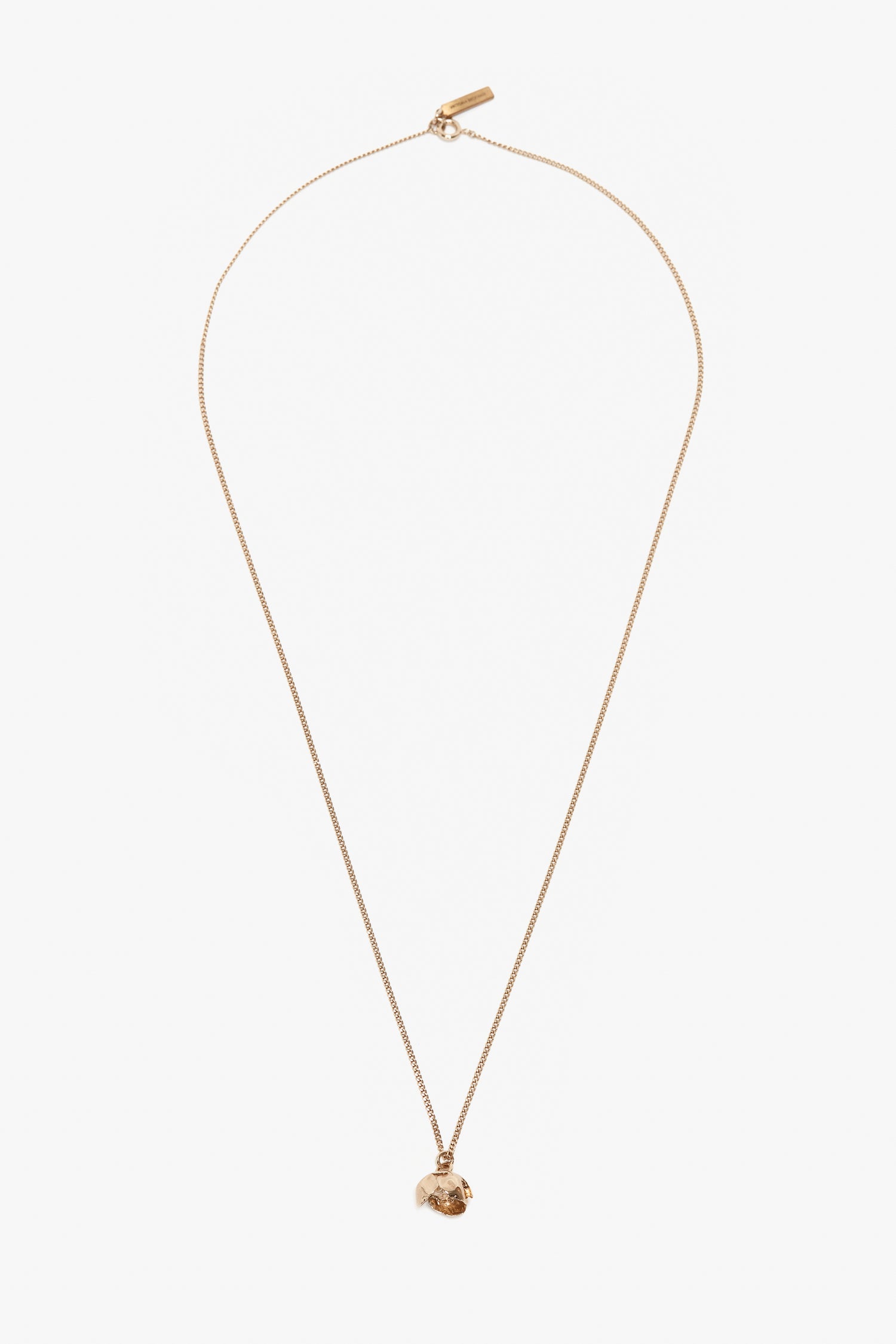A gold chain necklace featuring a small, intricately detailed Camellia Flower pendant, handcrafted in Italy and displayed against a plain white background is replaced with the Exclusive Camellia Flower Necklace In Gold by Victoria Beckham.