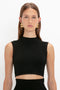 A person with long brown hair wearing a sleeveless black VB Body Scallop Trim Tank Top In Black by Victoria Beckham and gold geometric earrings, showcasing a versatile summer essential. They are standing against a white background.