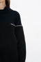 Partial view of a person wearing a Collar Detail Jumper In Navy by Victoria Beckham. The background is plain white.