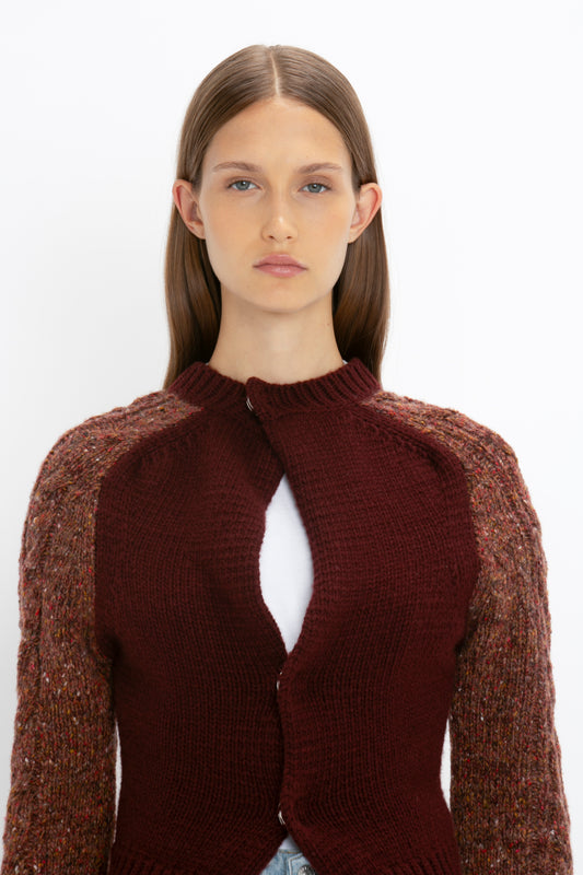 A person with long brown hair wears a maroon **Exclusive Contrast Sleeve Cardigan In Rust** by **Victoria Beckham** over a white top, standing against a plain white background.