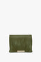 A Puffy Jumbo Chain Pouch In Khaki Leather by Victoria Beckham with a ruched design and a checker-patterned metallic clasp on the front, crafted from luxurious sheepskin nappa leather.