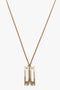 Exclusive Frame Necklace In Gold with a thin chain featuring a Frame Charm Pendant shaped like the letters "PA" in a modern style, reminiscent of Victoria Beckham accessories.