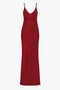 A poppy red, sleeveless, 1990s-inspired camisole-slip dress with a V-neckline displayed on a white background is the Low Back Cami Floor-Length Dress In Poppy Red by Victoria Beckham.