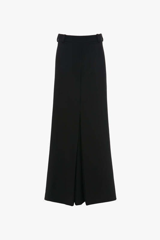 A Floor-Length Box Pleat Skirt In Black by Victoria Beckham features a front slit and belt loops at the waistband.