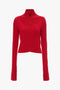 A long-sleeved red cable-knit sweater in luxurious merino wool knit, featuring a high crossover neckline and an asymmetrical hem from Victoria Beckham's Wrap Detail Jumper In Red collection.