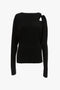 A black long-sleeve Twist Detail Jersey Top In Black by Victoria Beckham with a round neckline and a circular cut-out detail on one shoulder, made from luxurious liquid crepe jersey.