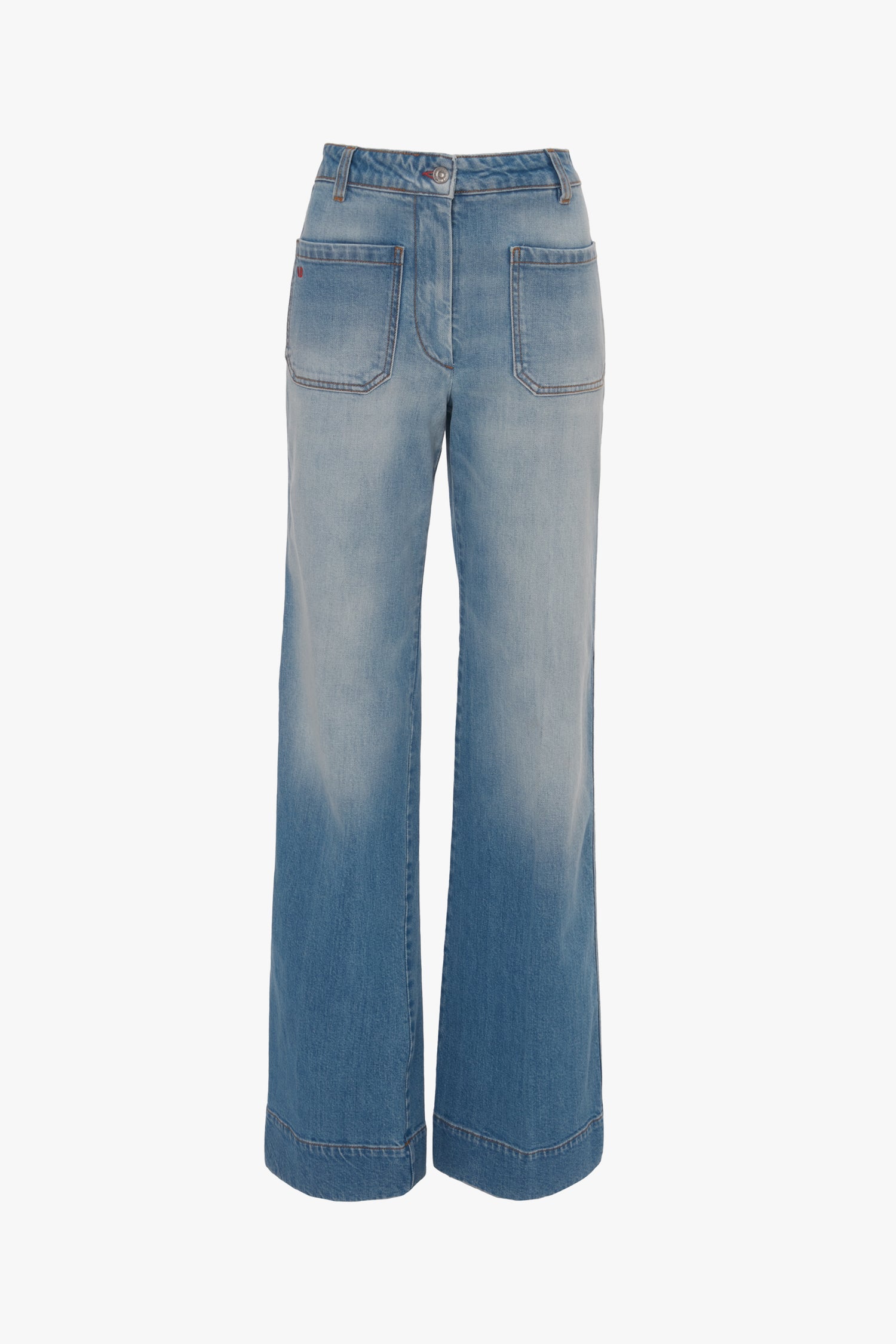 Wide-leg blue denim jeans with front pockets and a high waist. The Alina High Waisted Jean In Light Summer Wash by Victoria Beckham features vintage denim that is lightly faded for a slightly worn look.