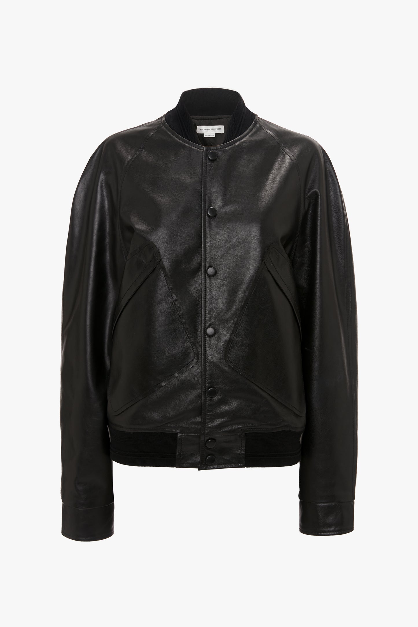 A Leather Varsity Jacket In Black by Victoria Beckham is displayed on a plain white background, featuring a button-up front and long sleeves made of smooth calf leather.