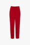 A pair of straight-leg, high-waisted Tapered Leg Trouser in Carmine from Victoria Beckham with a front seam detail, traditional tailoring elements, and a concealed waistband closure.