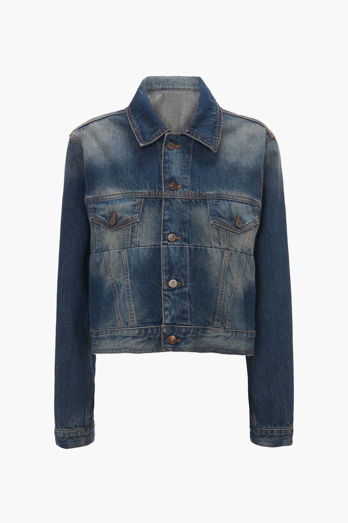 A Victoria Beckham Cropped Denim Jacket In Heavy Vintage Indigo Wash features a button-up front, two chest pockets with buttoned flaps, and long sleeves, displayed on a plain white background.