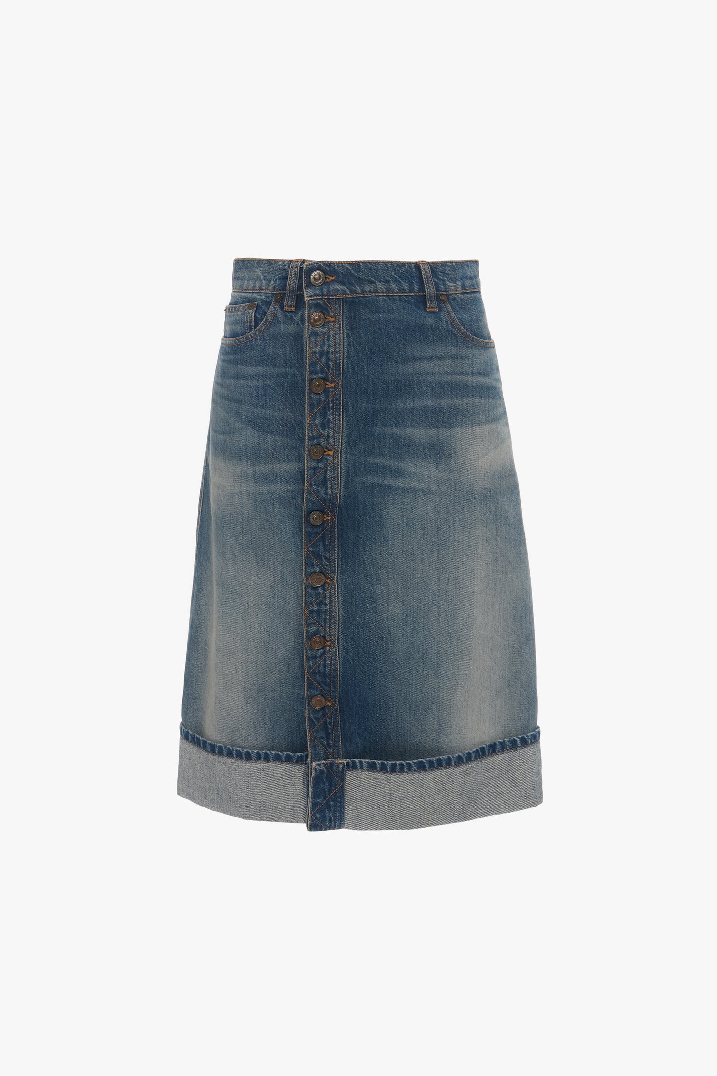 A knee-length luxury denim skirt with an asymmetric front placket closure, two front pockets, and a folded hem: the Placket Detail Denim Skirt In Heavy Vintage Indigo Wash by Victoria Beckham.