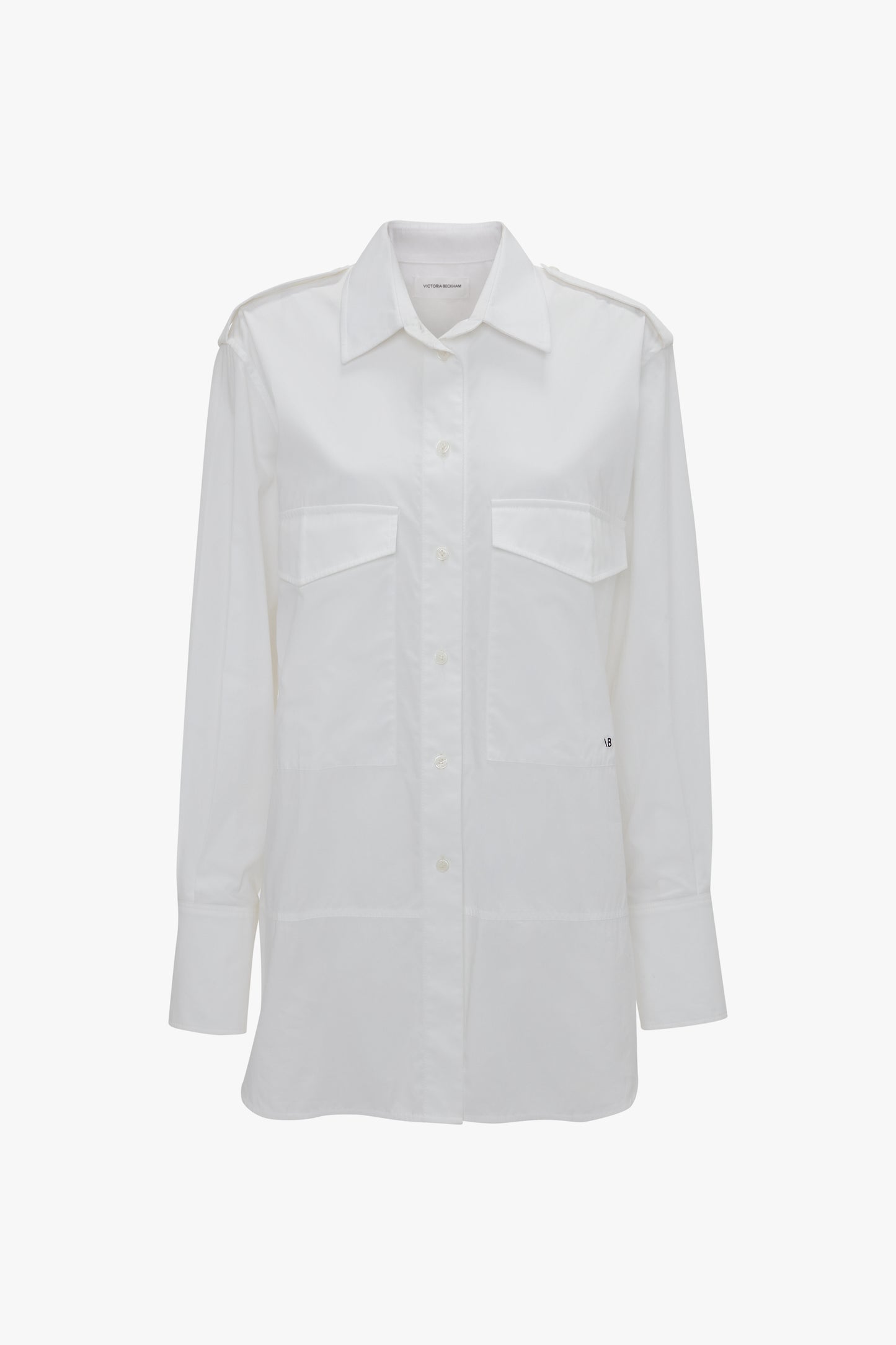 A white, long-sleeve button-down shirt made from organic cotton features two chest pockets and a collar, displayed against a plain white background. The Victoria Beckham Oversized Pocket Shirt In White offers both style and functionality for any wardrobe.