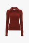 A Double Collared Jumper In Russet by Victoria Beckham, with a V-neck, crafted in luxurious cashmere, featuring long sleeves and a slightly fitted silhouette.