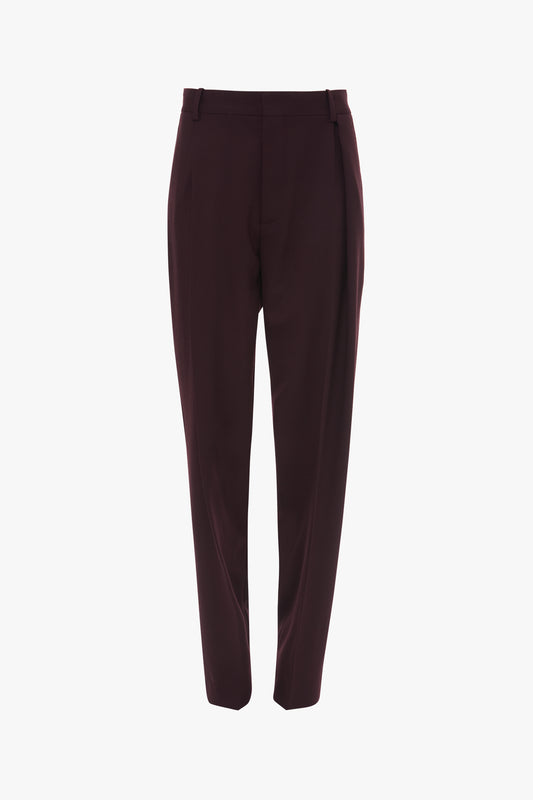 A pair of Asymmetric Chino Trouser In Deep Mahogany by Victoria Beckham with belt loops and front pleats, featuring a narrow leg silhouette, displayed on a white background.