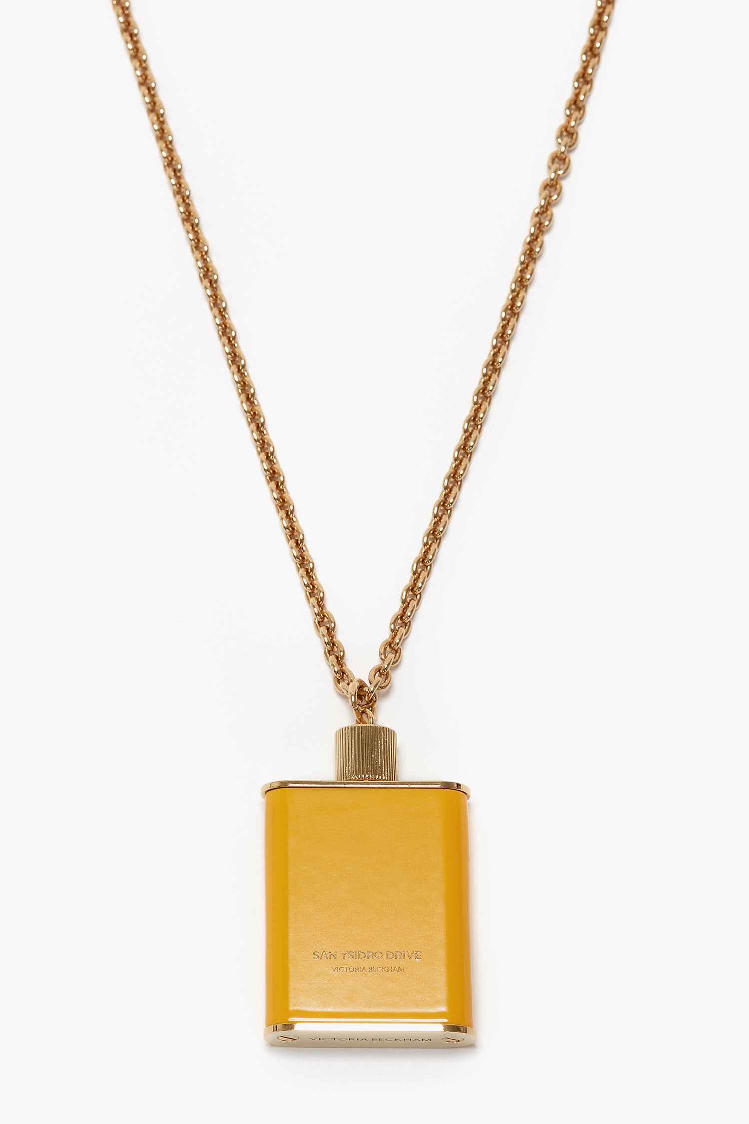 Gold brushed brass jewelry meets modern elegance with this Victoria Beckham Perfume Bottle Necklace In San Ysidro Drive, featuring a rectangular pendant that resembles a small flask.