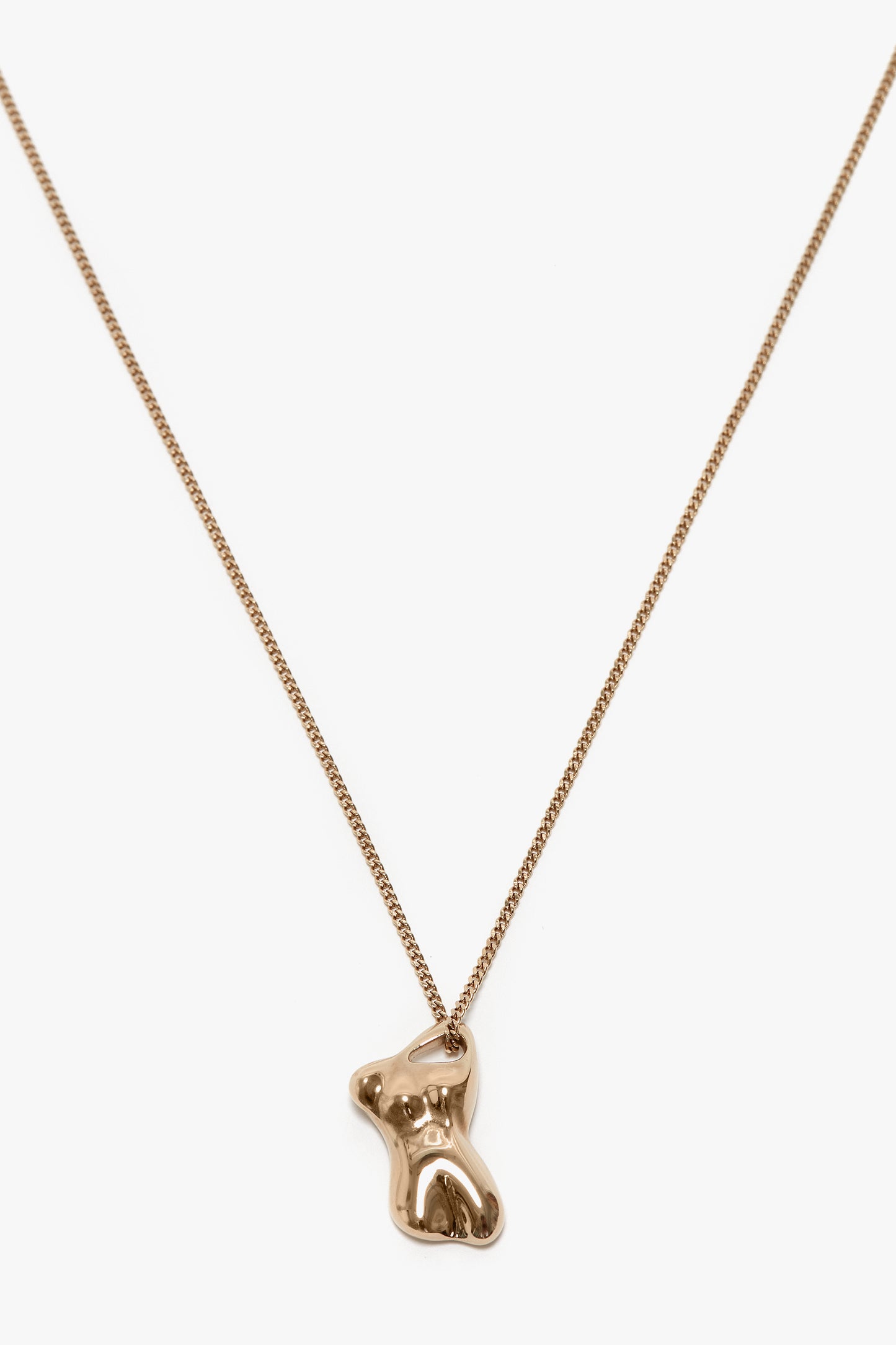 A Victoria Beckham Exclusive Body Charm Necklace In Light Gold with a 100% brass pendant shaped like a small, stylized teddy bear.