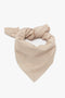 A taupe, triangular Leather Scarf In Taupe by Victoria Beckham with a knot at the top, crafted as an elevated essential.