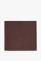 A rectangular brown Leather Scarf In Bordeaux with a bordered edge, reminiscent of the sleek lines found in masculine tailoring, by Victoria Beckham.